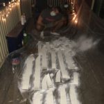 Sal, priming comically large foam feathers, in the dead of night.